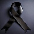 Close Up Photo Of A Black Condolence Ribbon On A Plain Background