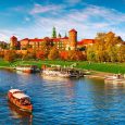 Wawel castle famous landmark in Krakow Poland. Picturesque landscape on coast river Wisla. Autumn sunset with white sky and cloud.