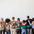 Rearview of diverse people hugging each other