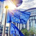 EU flags waving in front of European Parliament building. Brussels, Belgium